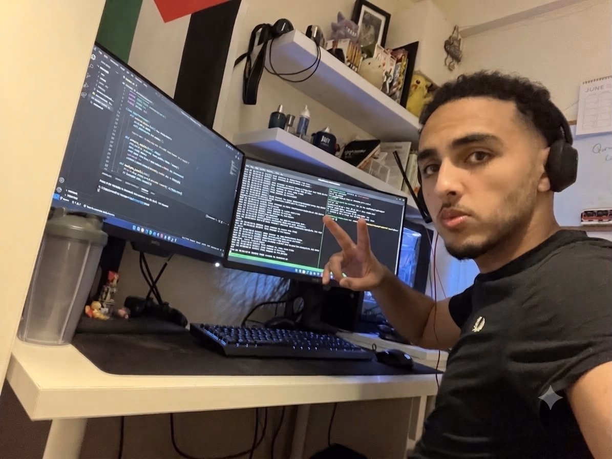 Hamza at his desk, dual monitors running an editor and a terminal